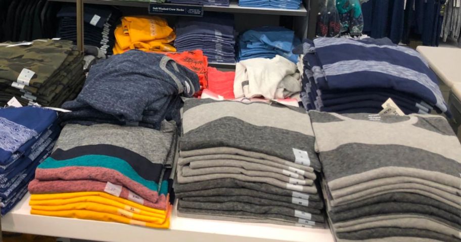 Old navy mens tees folded and stacked on a display table