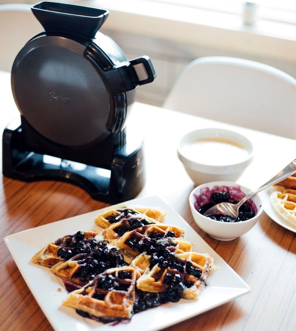 Plate of waffles next to a waffle maker