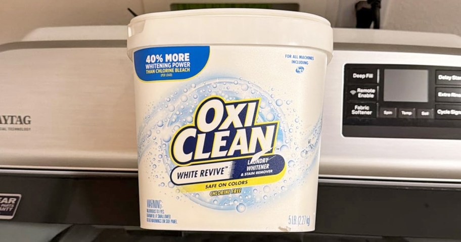 container of OxiClean White Revive powder on top of a washing machine