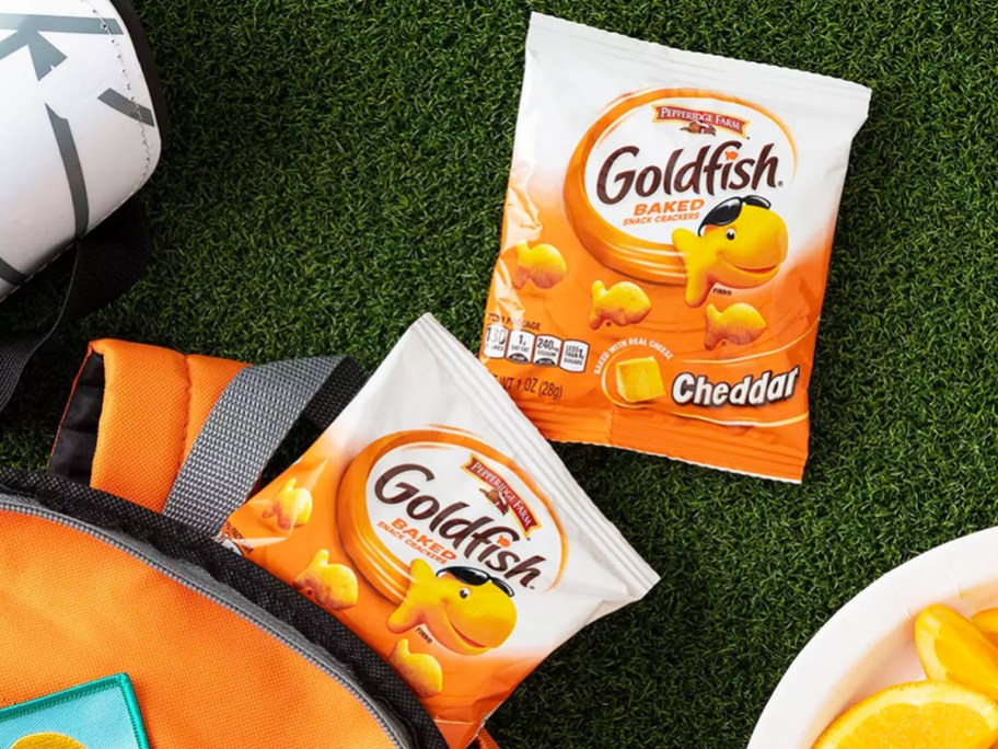 two packs of goldfish coming out of backpack