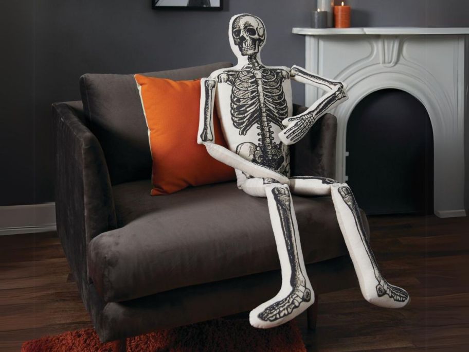 Place & Time 52" x 16" Halloween White Figural Skeleton Pillow on couch