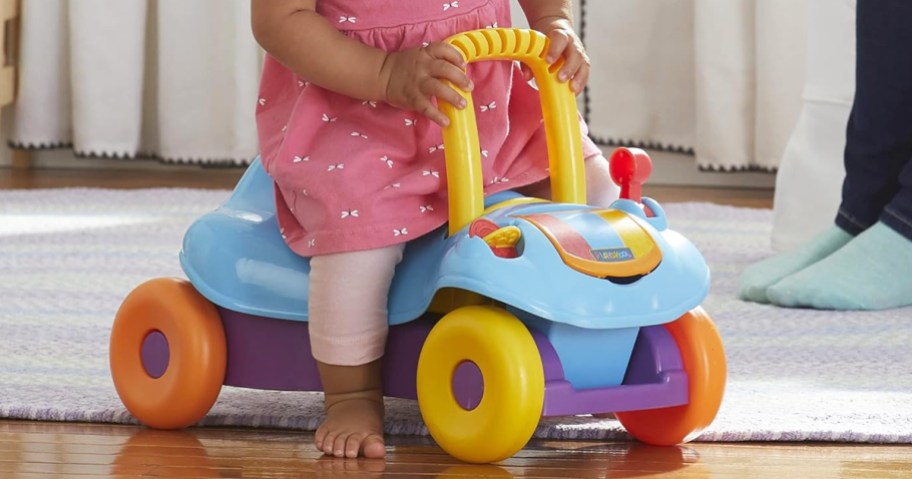 toddler riding on colorful ride-on toy