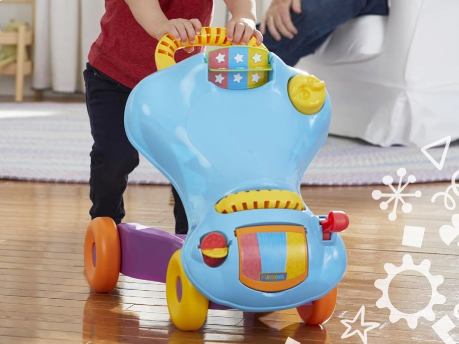 toddler pushing blue walker toy