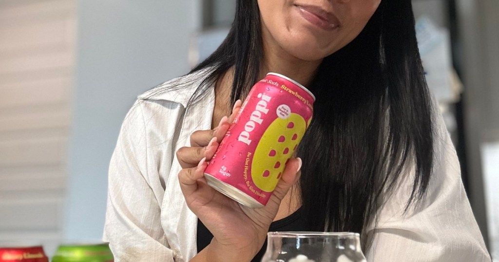 Woman holding up a can of Poppi prebiotic soda