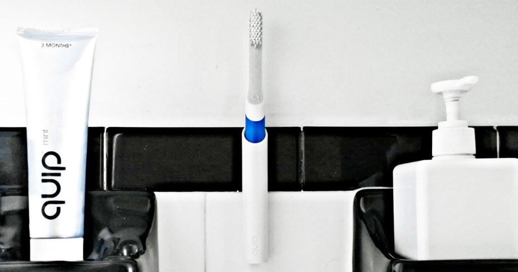 blue and white toothbrush in holder on wall