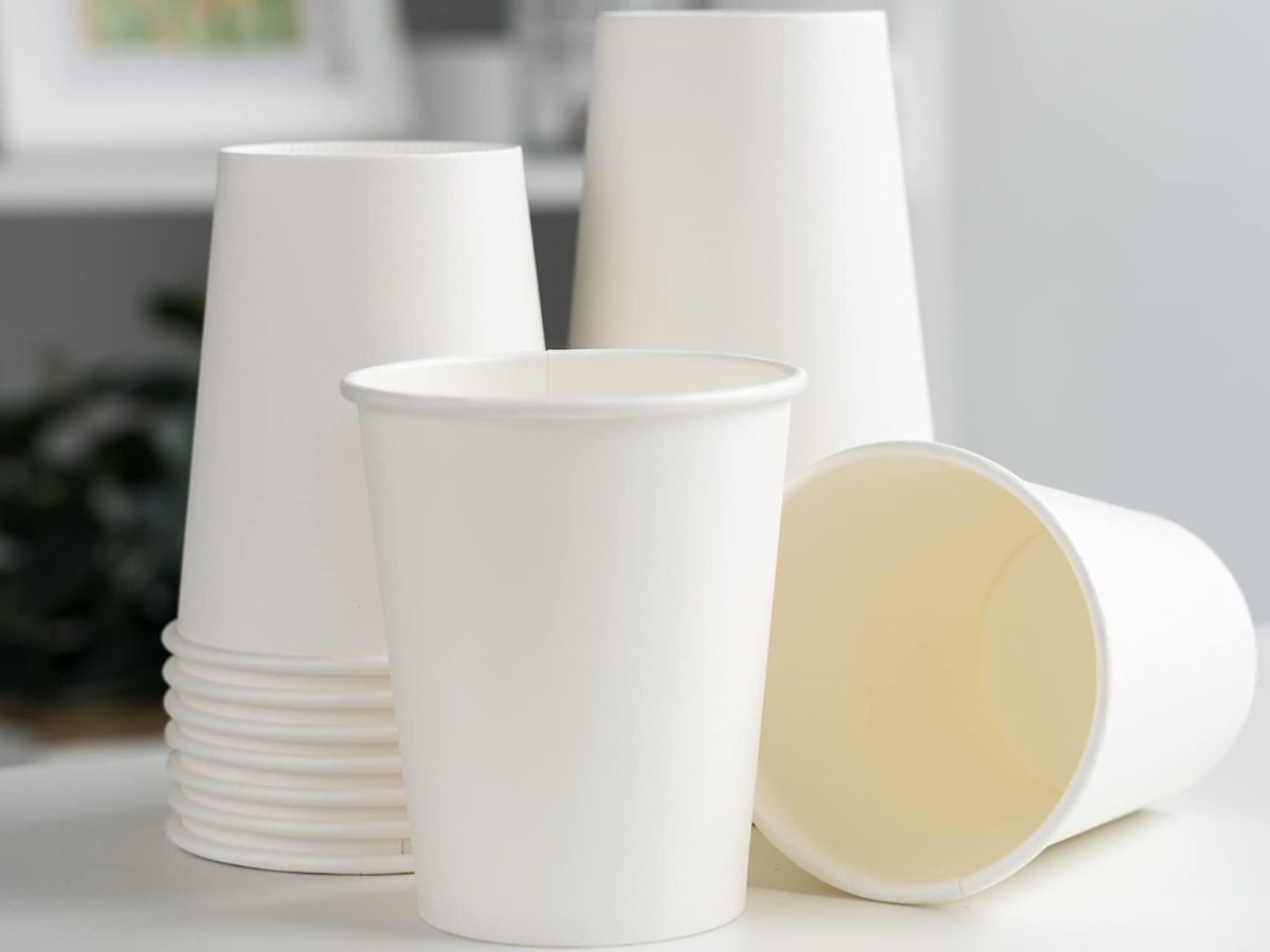 A few white paper cups on a countertop