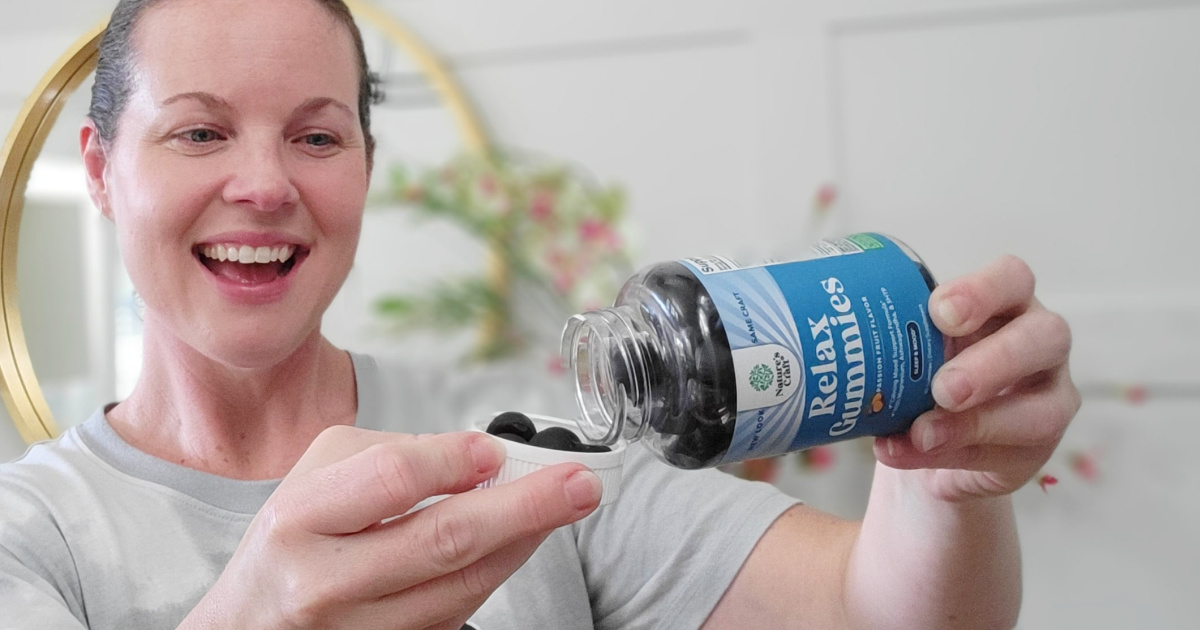 woman with bottle of gummy vitamins 