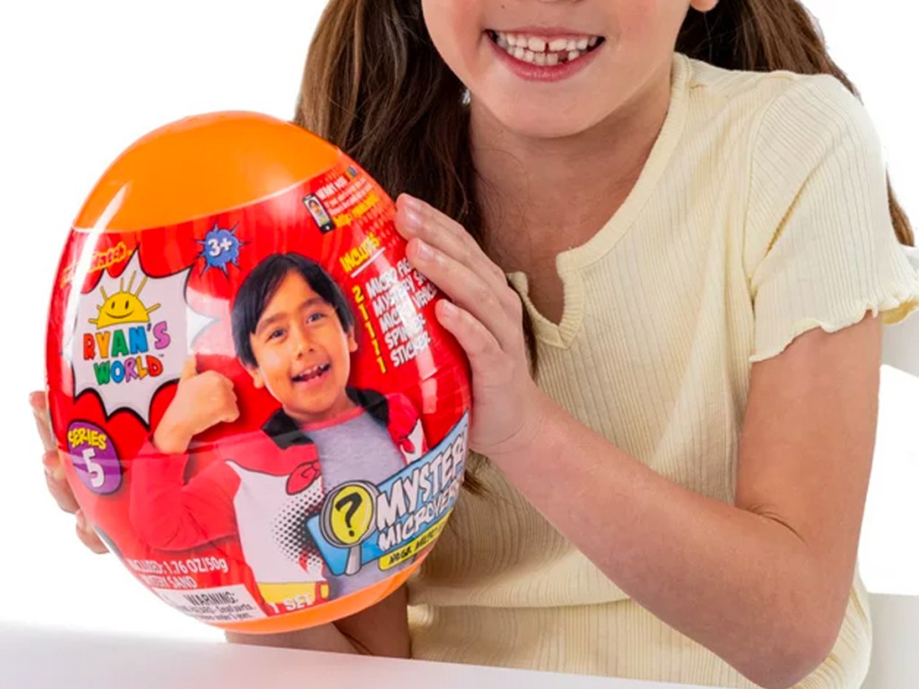 Girl holding a Ryan's World Mega Micro Mystery Egg Series 5