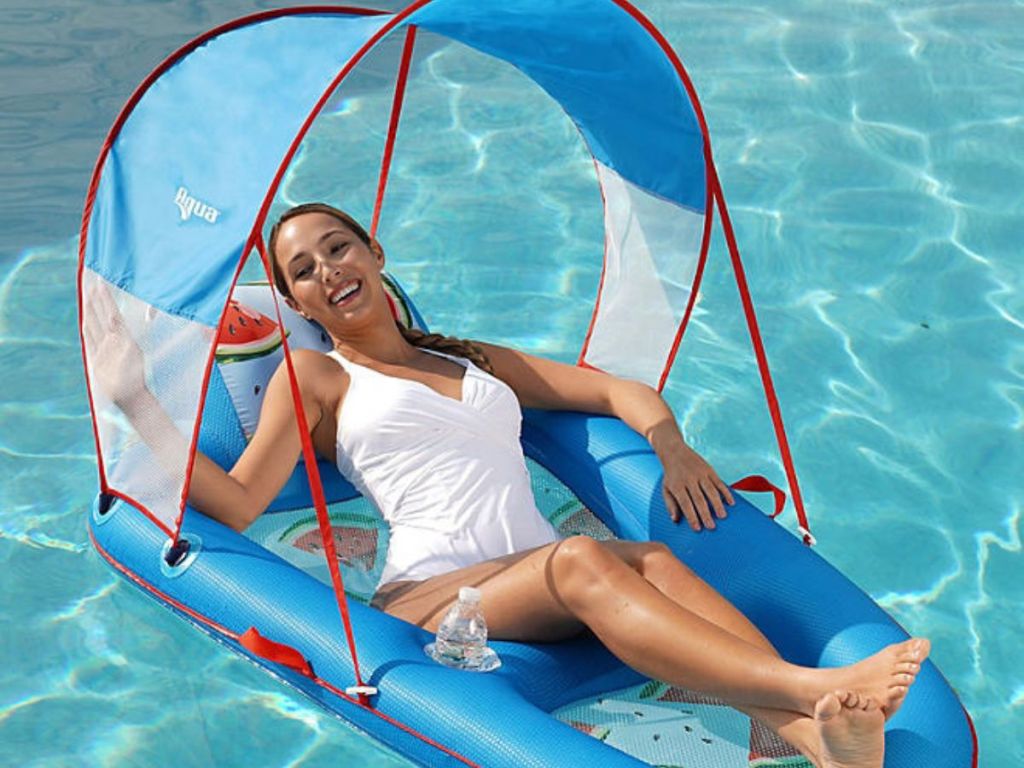 Woman relaxing in a pool in a pool lounger