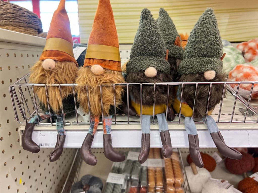 Decorative Gnomes with fall colors and dangling legs on shelf at Target