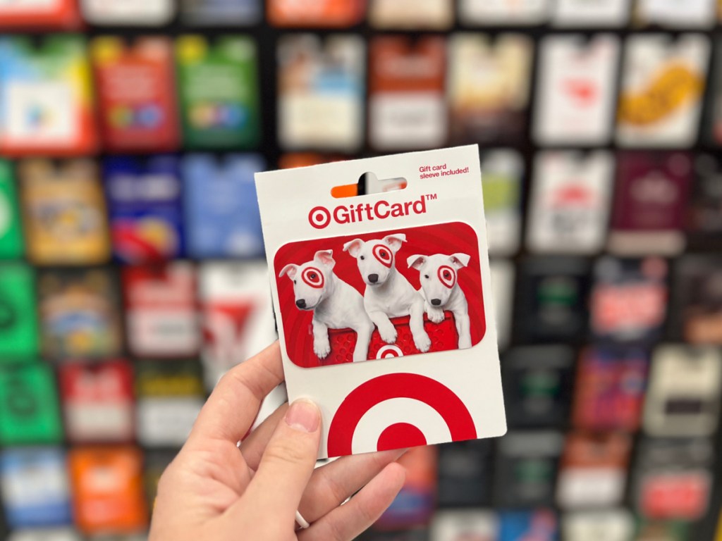 person holding target gift card in store