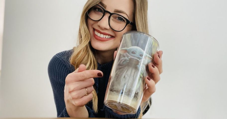 Woman holding a Tervis Tumbler with Grogu on it