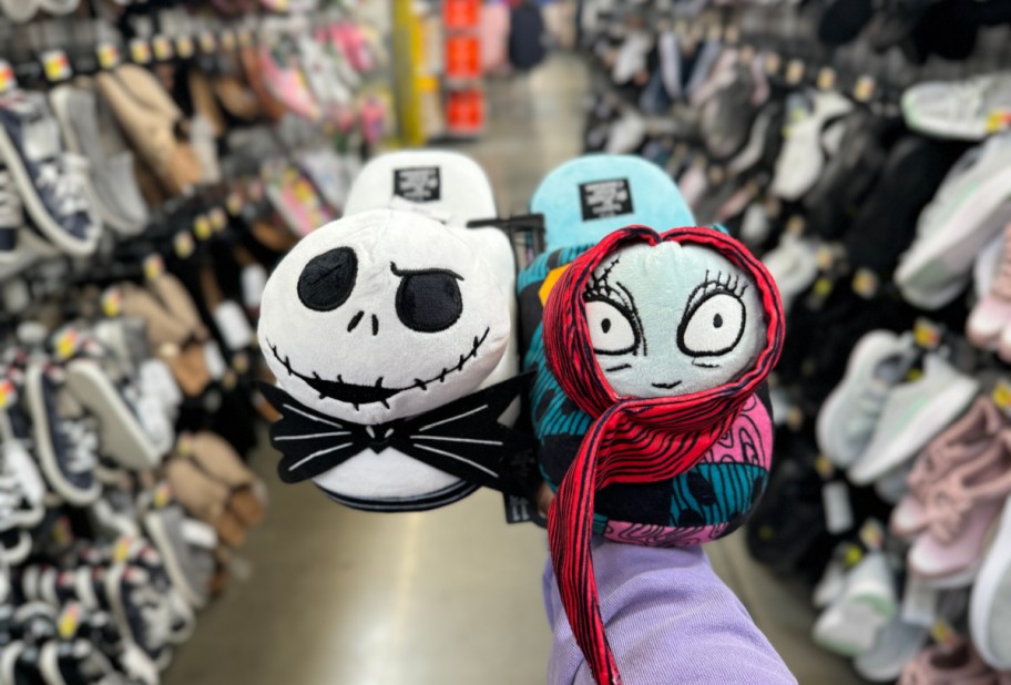 Hand holding up Nightmare Before christmas slippers of Jack Skellington and Sally