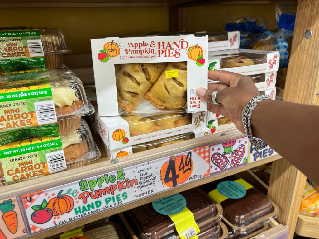 A hand holding Trader Joe's Apple and Pumpkin Hand Pies