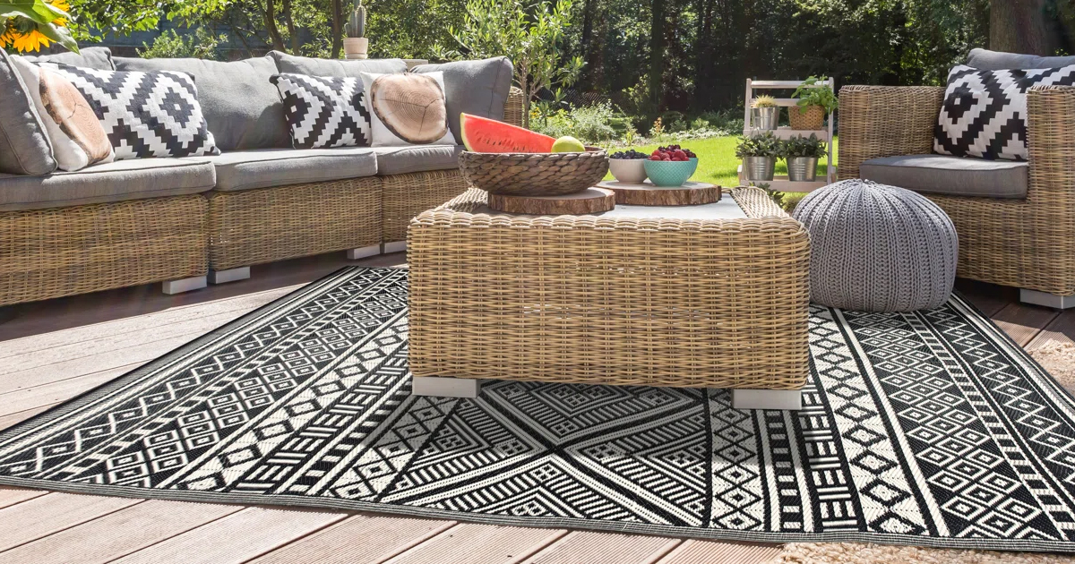 black and white rug under patio set on deck