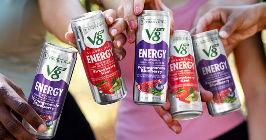 hand holding cans of V8 +ENERGY drinks