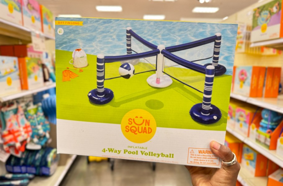 Hand holding up the box of an inflatable volleyball net set from target