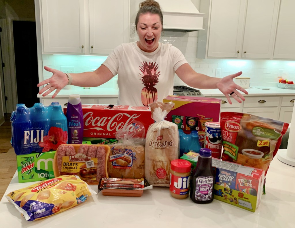 A woman at an AirBNB standing next to her Walmart plus grocery delivery order