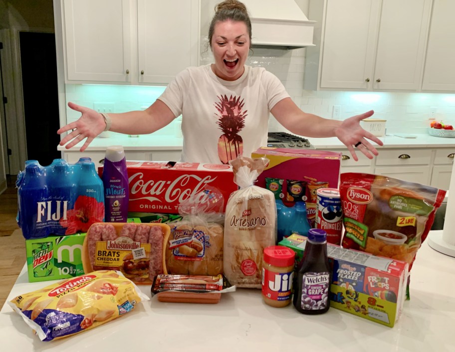 A woman at an AirBNB standing next to her Walmart plus grocery delivery order
