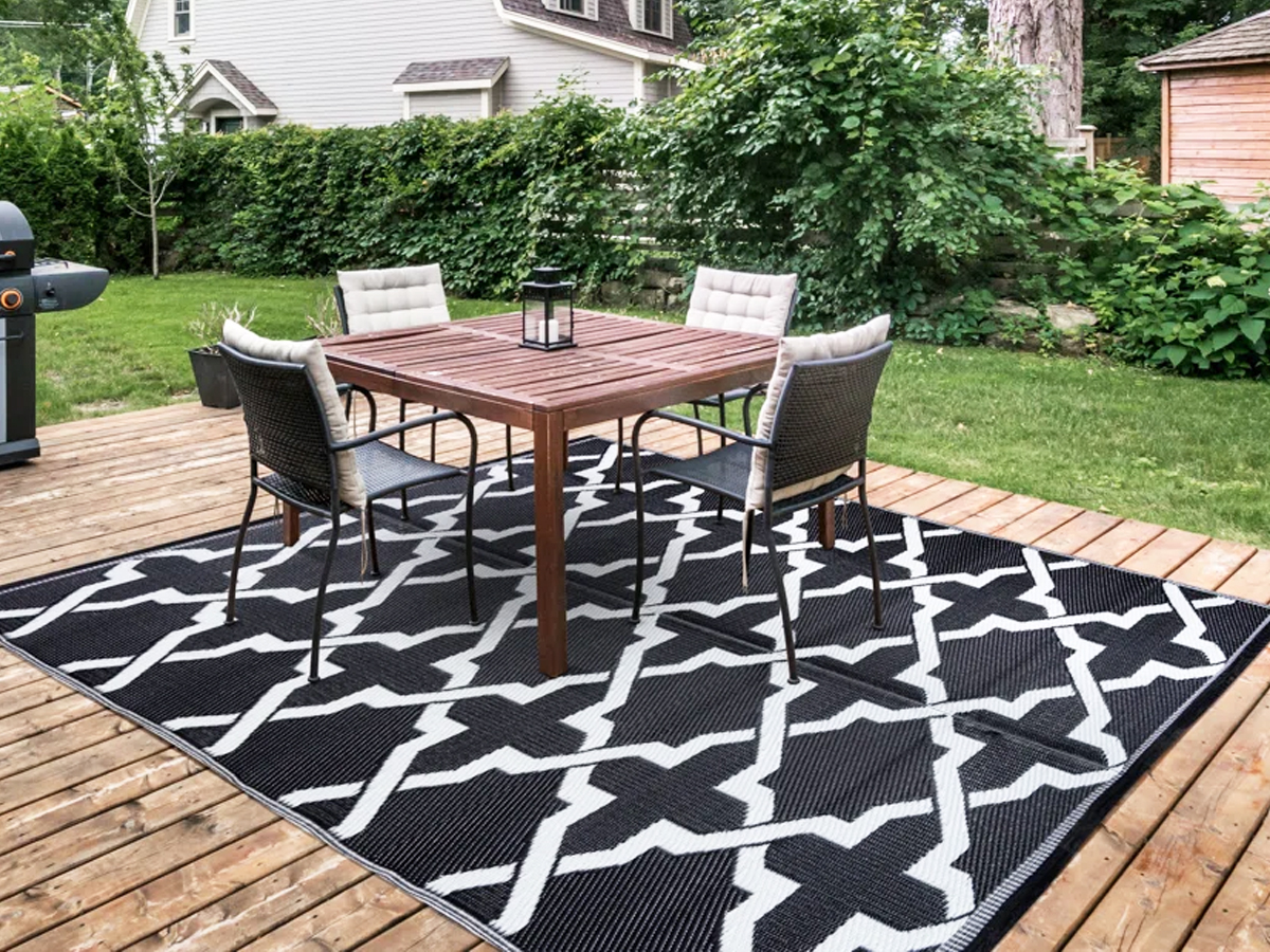 black and white rug under patio set on deck
