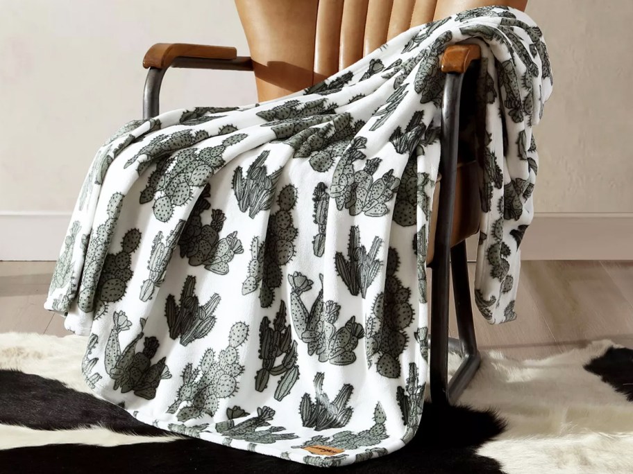 cactus print throw blanket draped over a chair