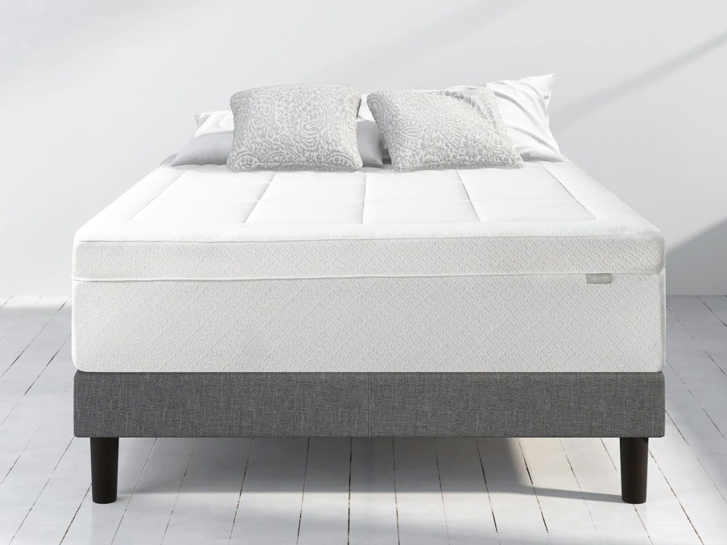 mattress with a topper and pillows on top