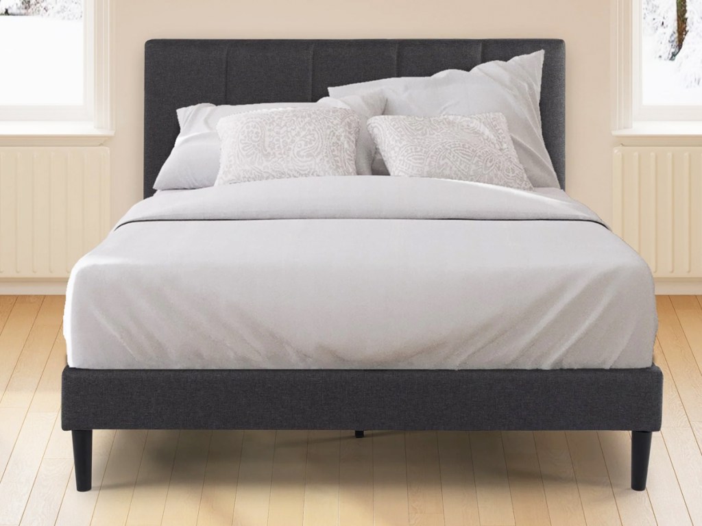 bed on a dark grey bed frame with matching headboard