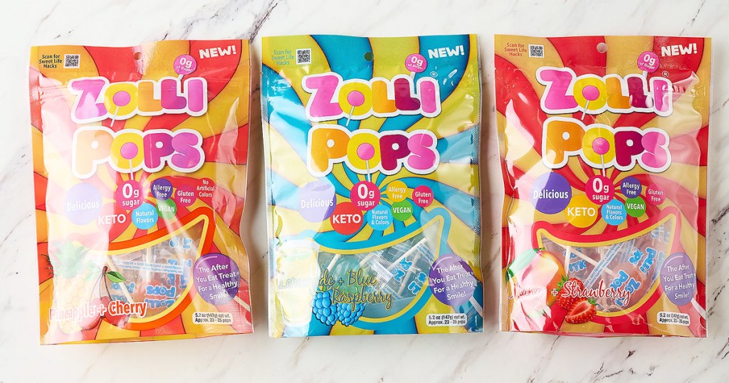 three large colorful bags of Zollipops