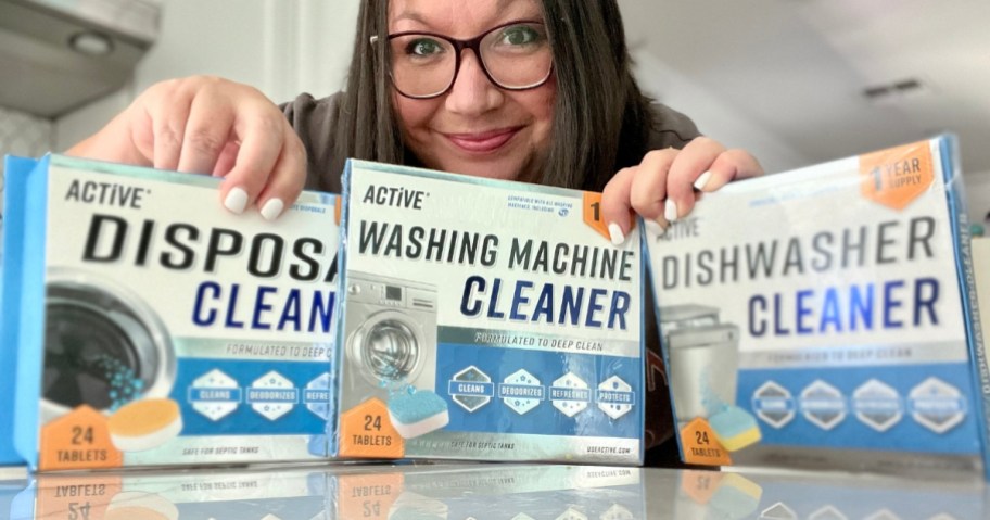 woman standing behind 3 boxes of Active Cleaners that are on a counter