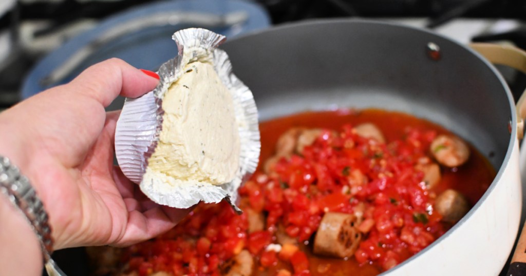adding Boursin cheese to a skillet