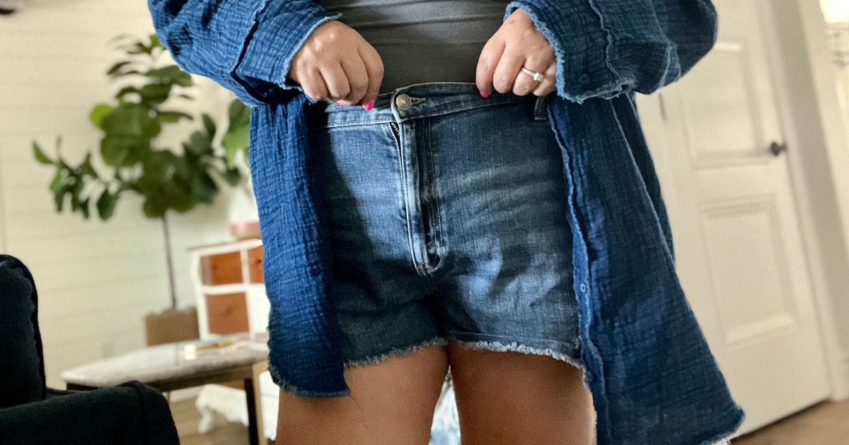 a woman from the waist down wearing a pair of blue distressed denim aerie daydream shorts