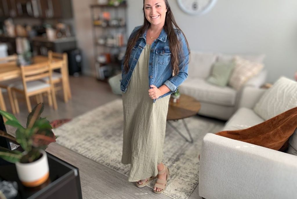woman standing in living room wearing maxi and jean jacket