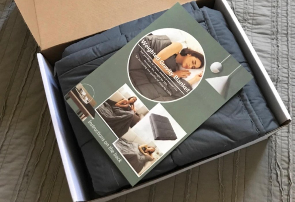 weighted blanket in box on bed