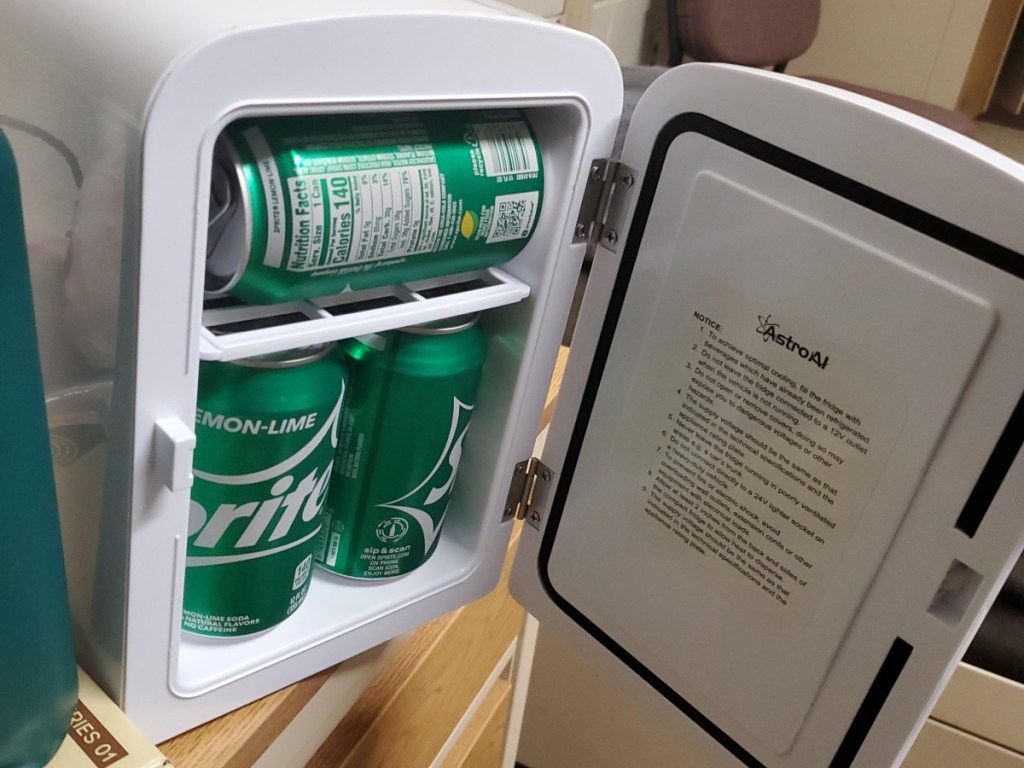 mini fridge holding cans of sprite