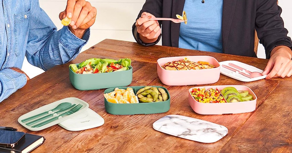 two people eating out of bentgo boxes on table