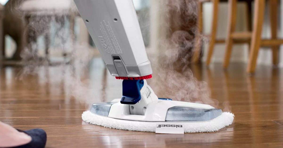 a woman using a bissell steam mop on hardwood floors 