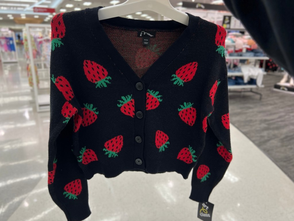 black with strawberries cardigan from Target in woman's hand
