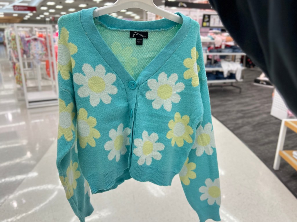 blue with flowers cardigan from Target in woman's hand