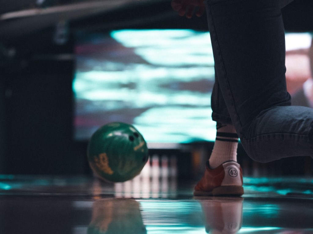 low view of a person bowling from behind