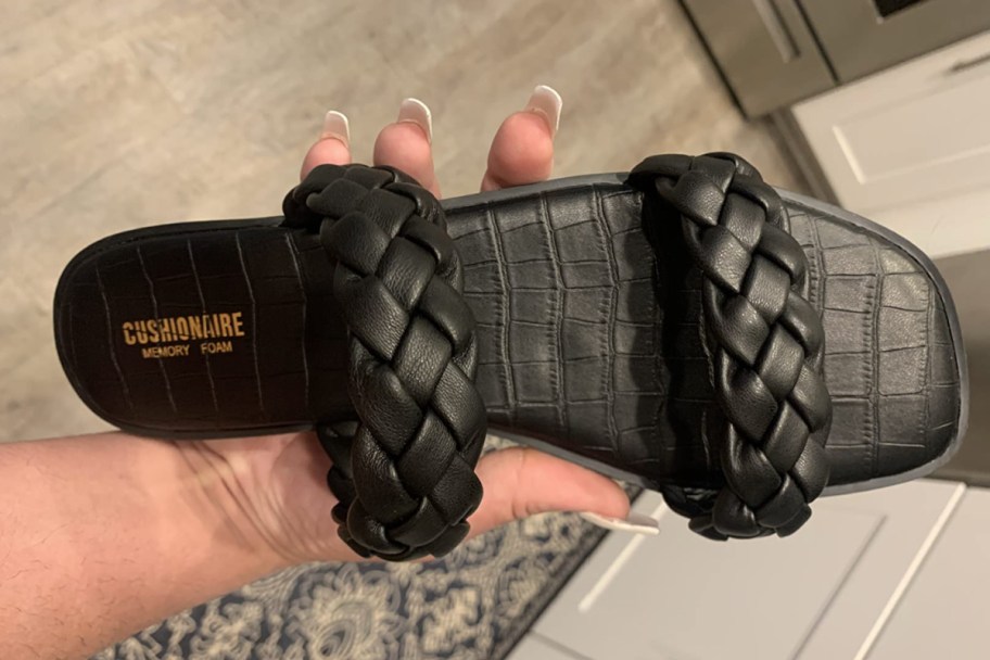 hand holding black double braided sandal