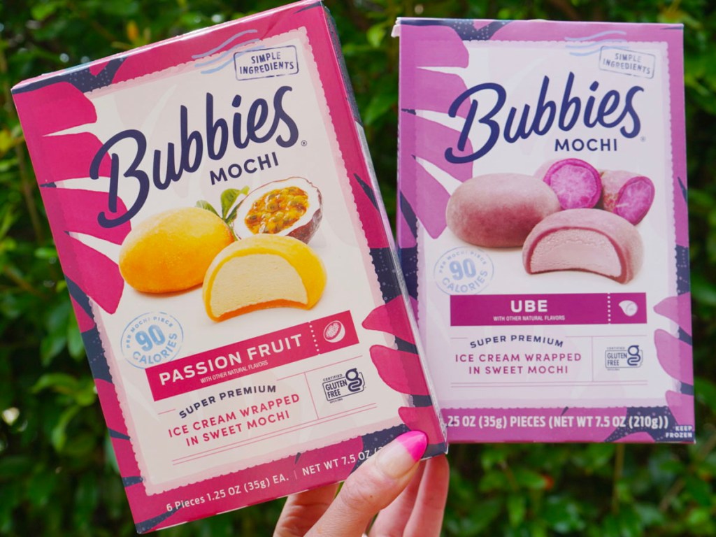 hand holding bubbies mochis passion fruit and ube flavored