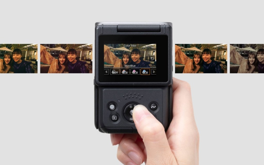 hand holding vlogging camera near picture strip