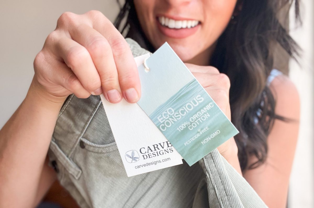 woman holding clothes tag