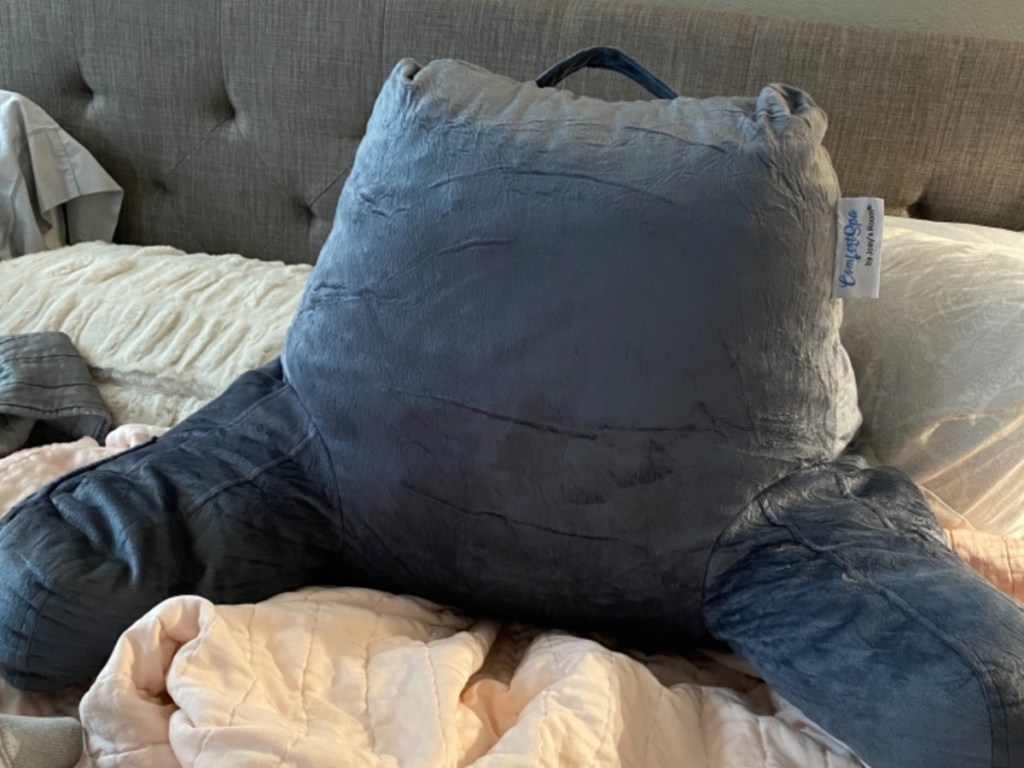 gray reading pillow on bed