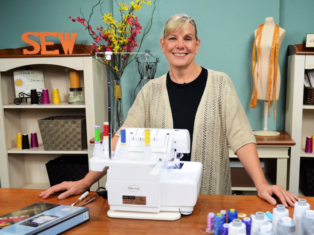 woman standing behind a sewing machine