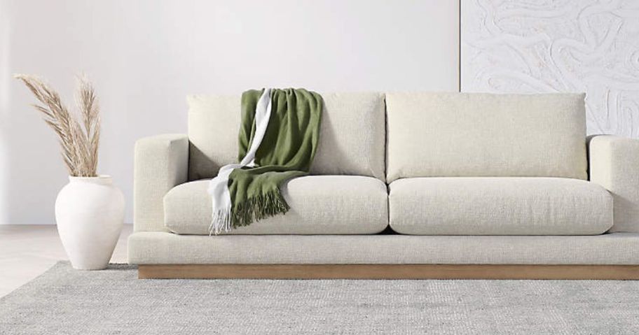 crate and barrel items with blanket on couch