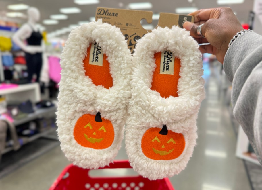 hand holding up dearfoam women's pumpkin slide slippers from target