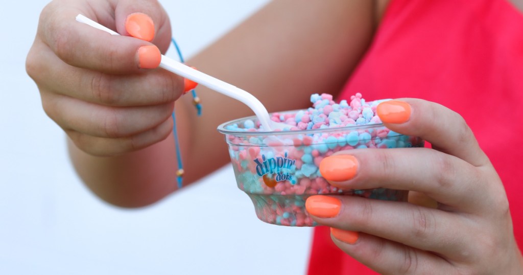 woman holding a cup of dippin dots