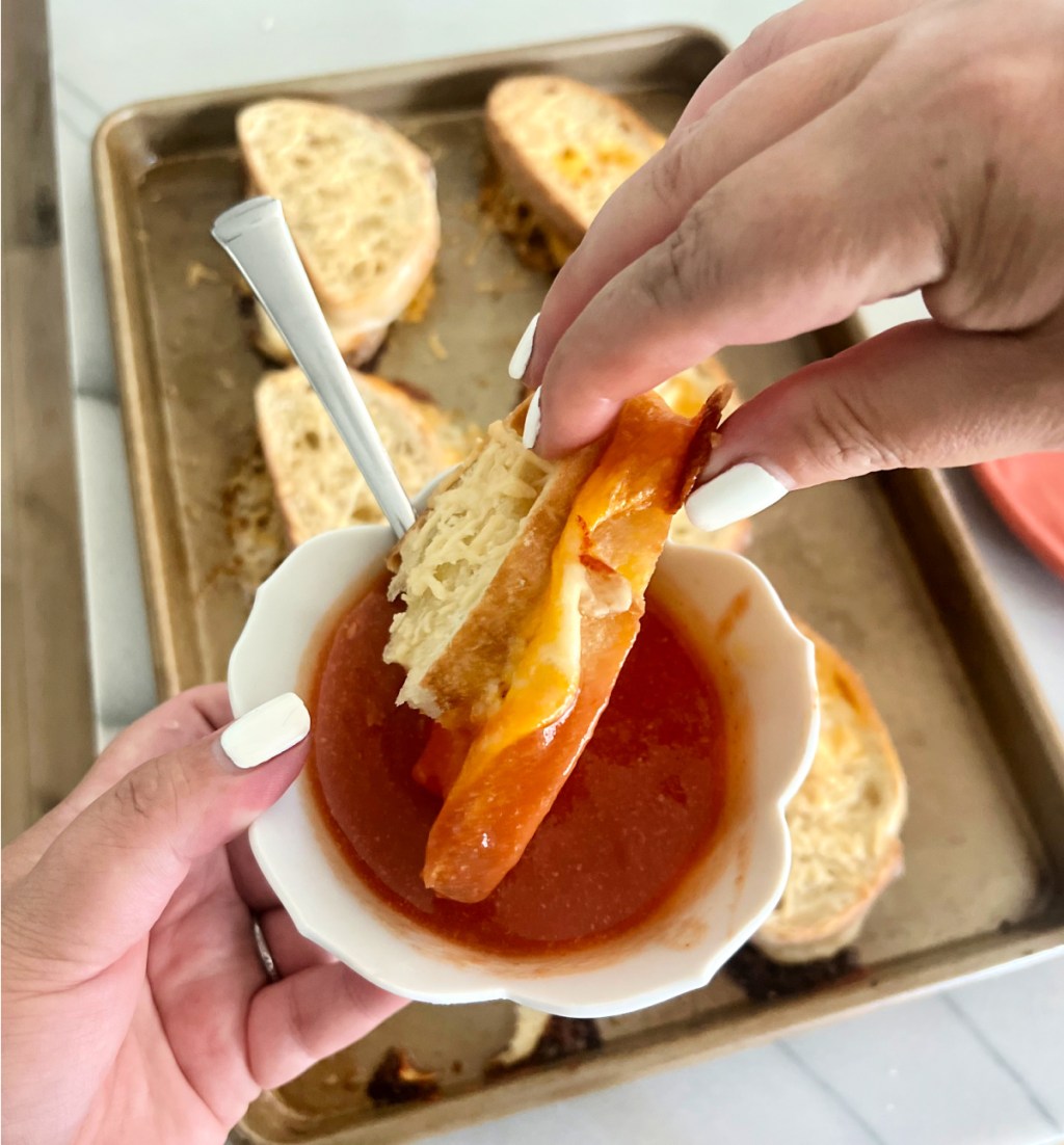 dipping sheet pan baked grilled cheese in tomato soup
