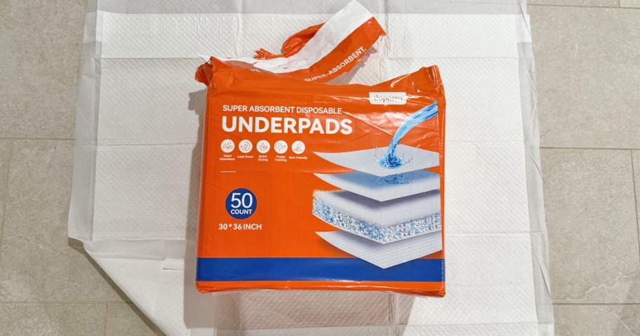 orange pack of puppy pads on top of a pad